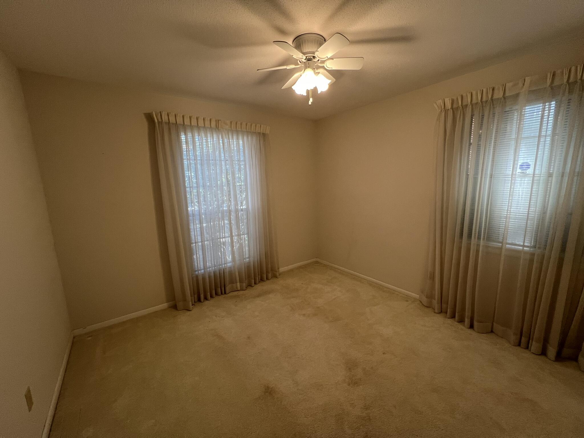 18 Sherwood Road Northwest Fort Walton Beach, FL 32547 - Photo 27 of 49 an empty room with windows and fan