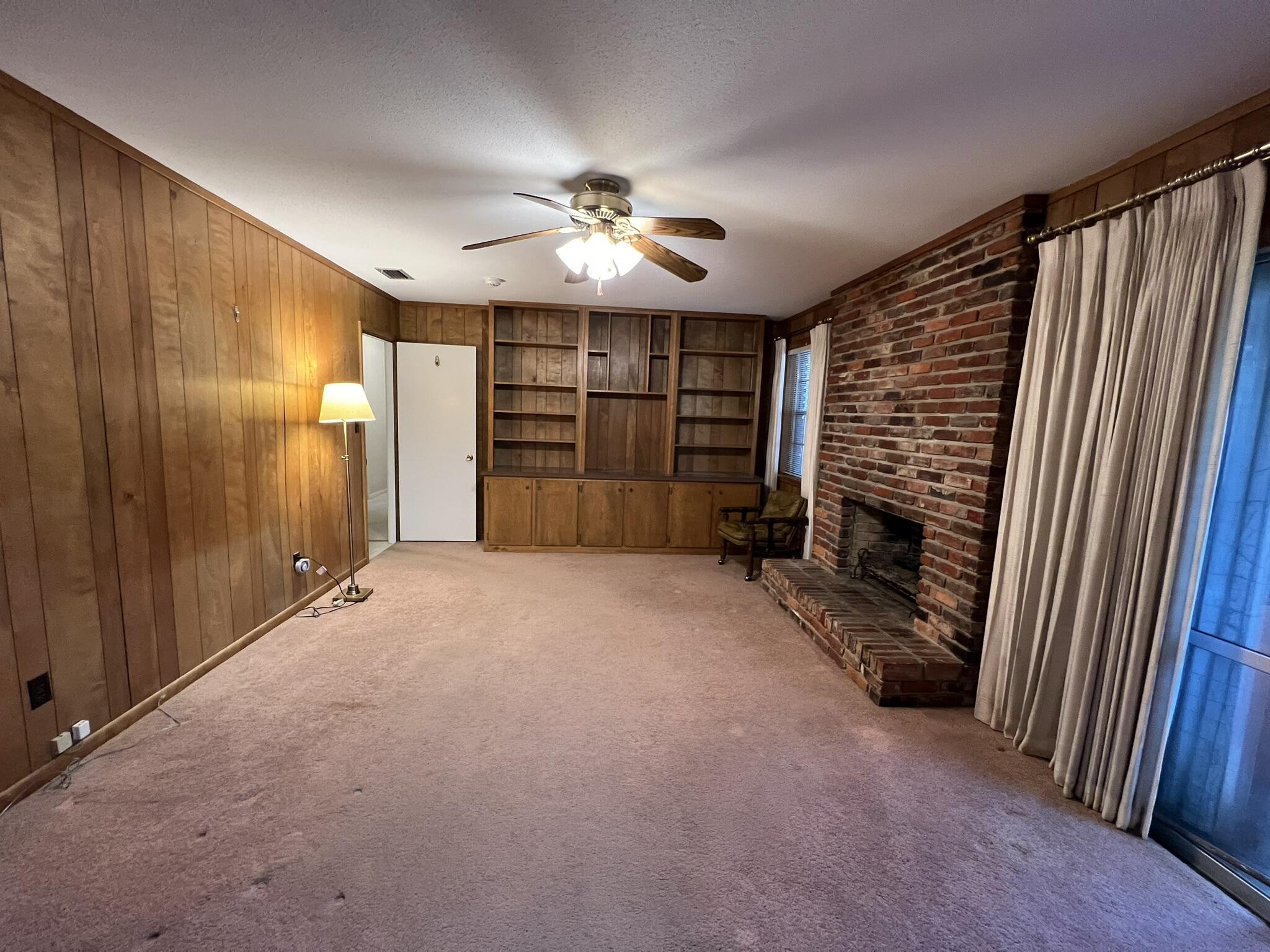 18 Sherwood Road Northwest Fort Walton Beach, FL 32547 - Photo 8 of 49 a view of empty room with a fireplace and fan