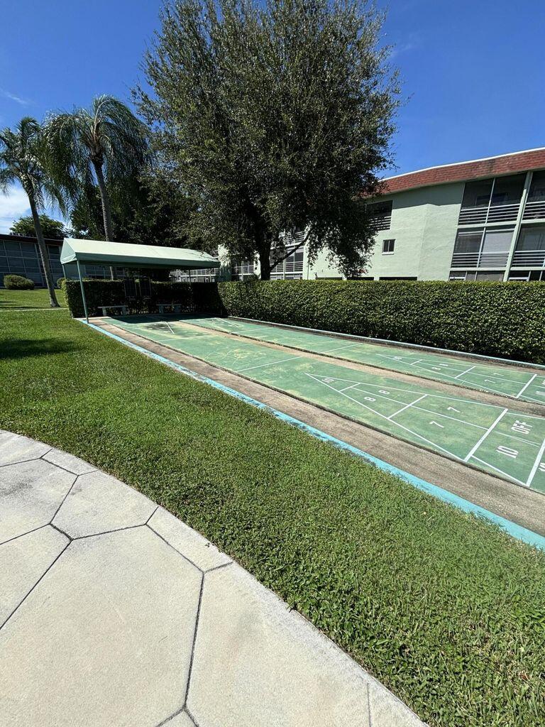 3400 Springdale Boulevard, Unit 217 Palm Springs, FL 33461 - Photo 13 of 15 a view of a house with a yard