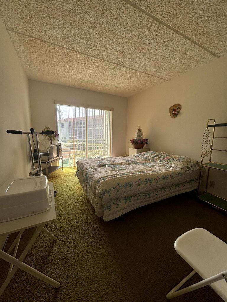 3400 Springdale Boulevard, Unit 217 Palm Springs, FL 33461 - Photo 6 of 15 a bedroom with a bed window and couch