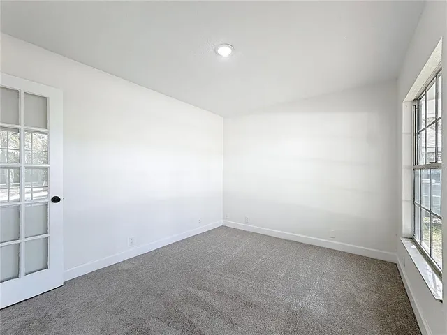 a kitchen with refrigerator and window