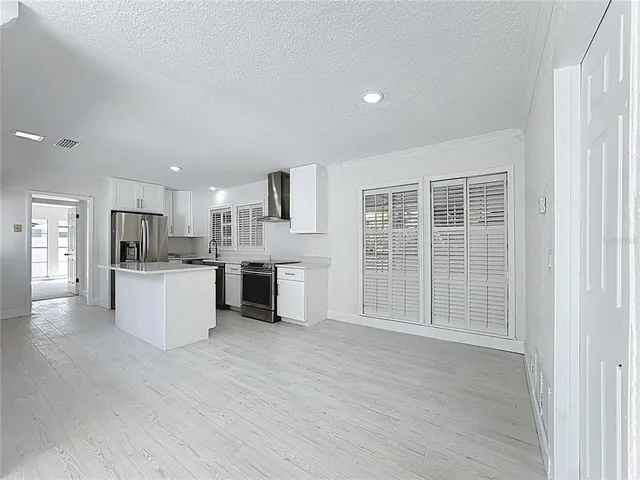 a view of empty room with wooden floor and cabinet