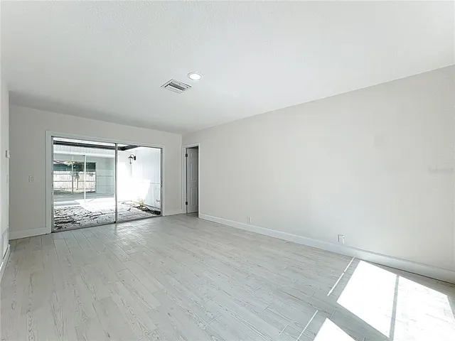 a view of an empty room and a window