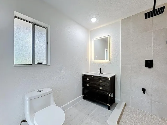 a view of a hallway with wooden cabinet and a kitchen
