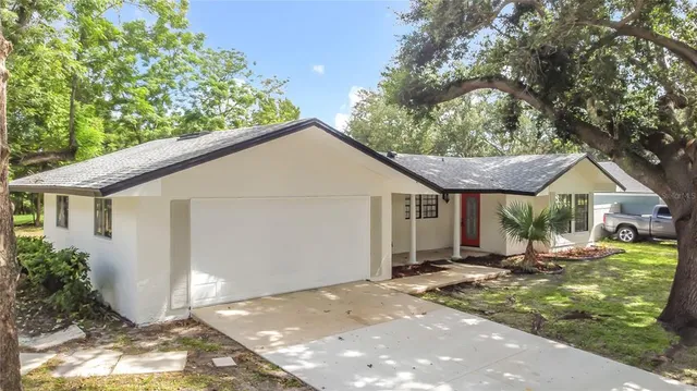 a view of a hallway with wooden floor and entryway