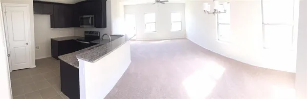 a view of a kitchen from the hallway