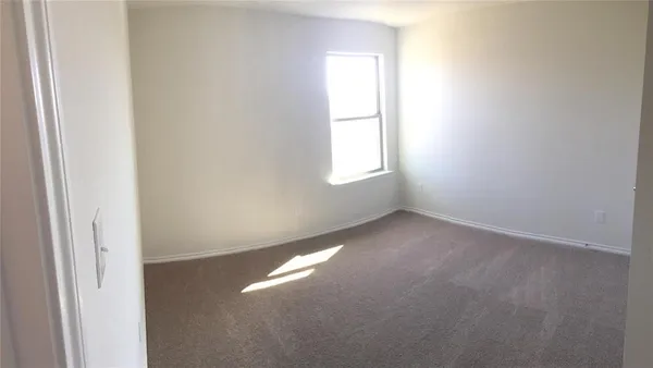 a view of an empty room and a window