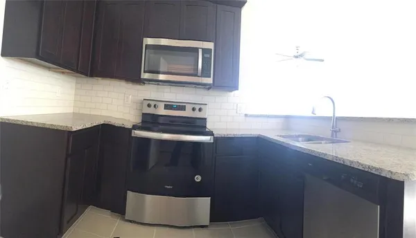 a kitchen with a sink and cabinets