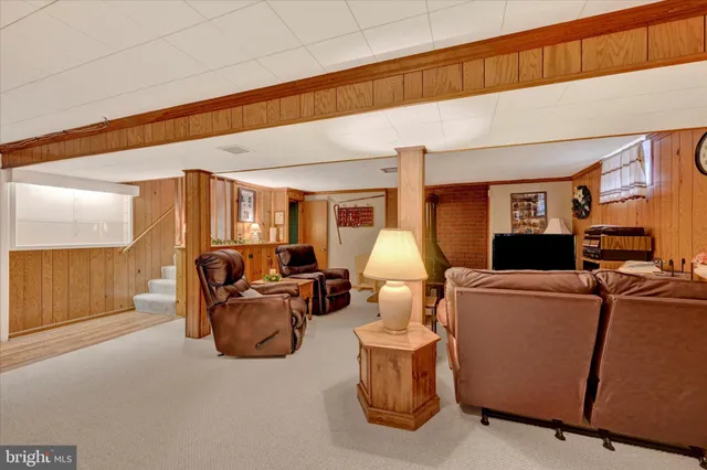 a living room with furniture a window and red lamp
