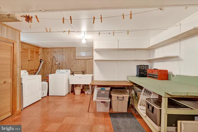 a kitchen with stainless steel appliances a stove a sink and white cabinets