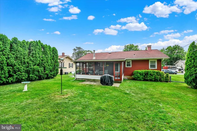 a front view of house with yard and outdoor seating