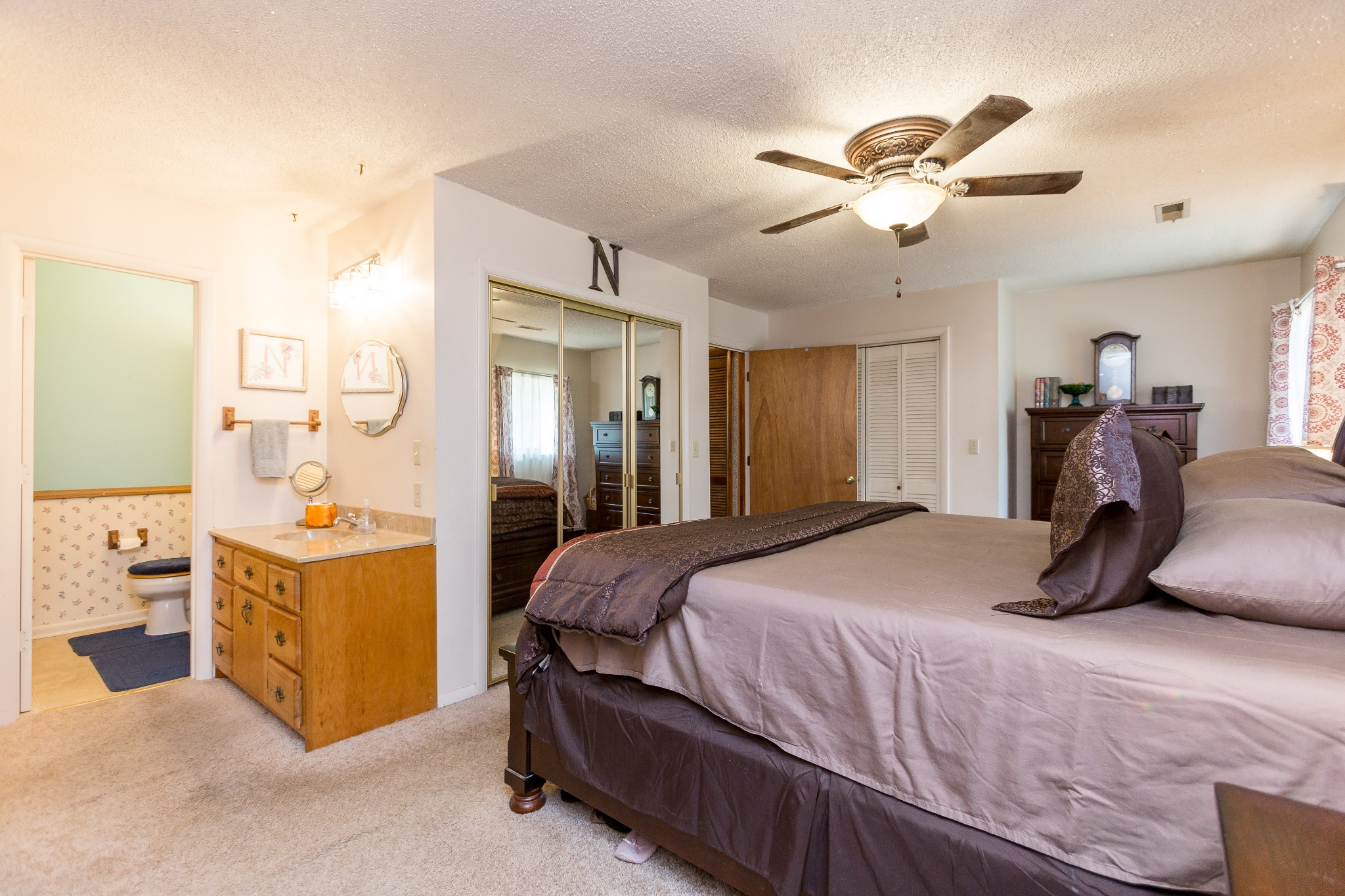 5101 New Chapel Road Springfield, TN 37172 - Photo 11 of 41 a bedroom with a bed and a chandelier