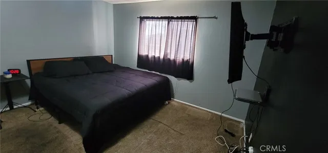 a bed sitting in a bedroom next to a window