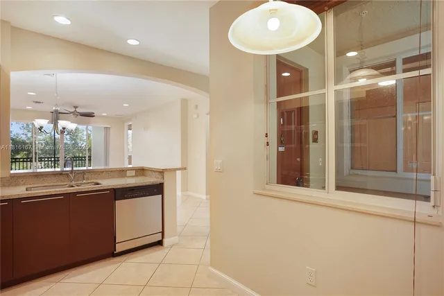 a kitchen with stainless steel appliances granite countertop a sink and cabinets with wooden floor