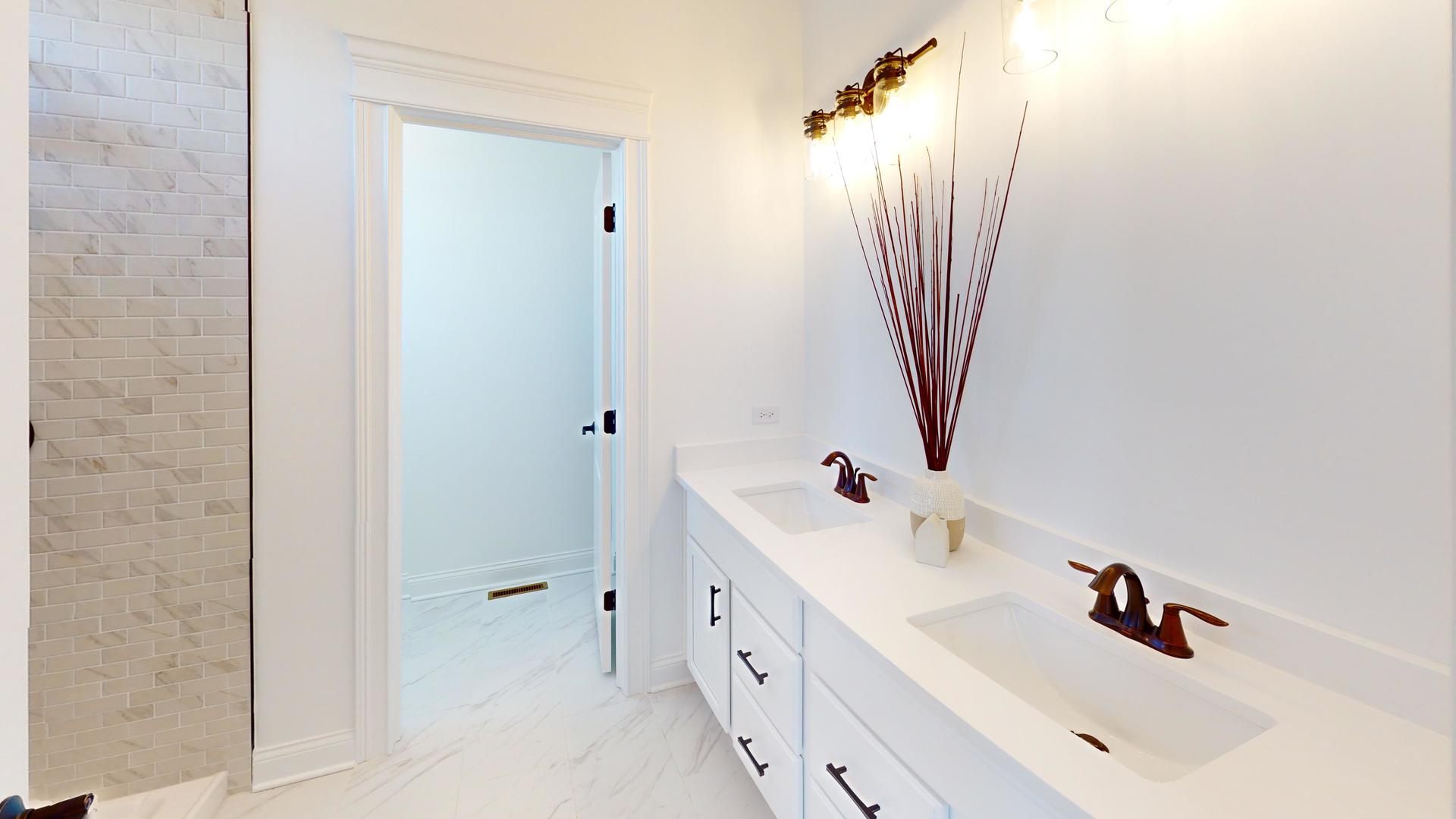 138 Trumpet Vine Circle Elgin, IL 60124 - Photo 23 of 46 a bathroom with a double vanity sink a mirror and shower