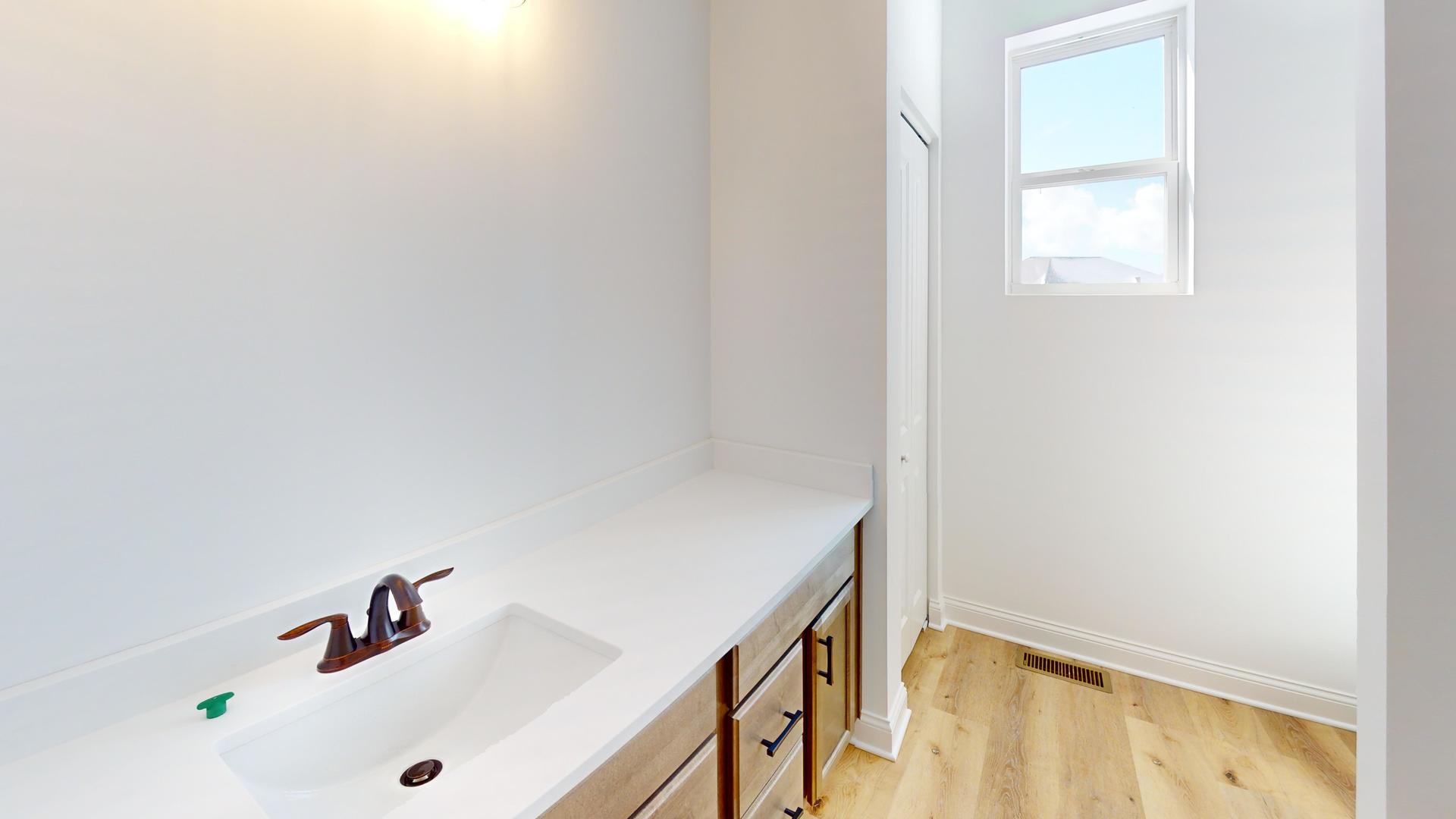 138 Trumpet Vine Circle Elgin, IL 60124 - Photo 25 of 46 a bathroom with a sink and a window