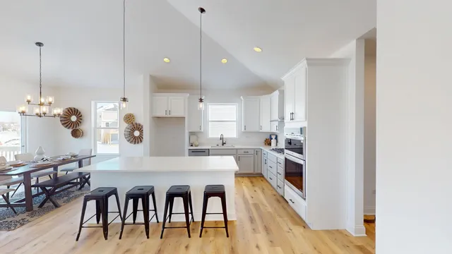 a large kitchen with a table and chairs