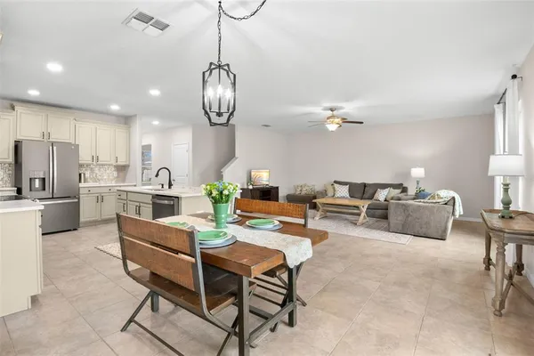 a living room with couches kitchen view and kitchen view