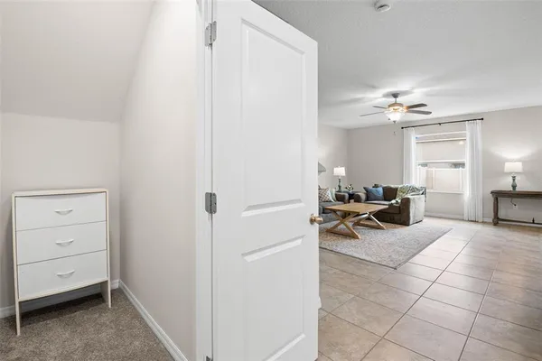 a view of a livingroom with furniture and a ceiling fan