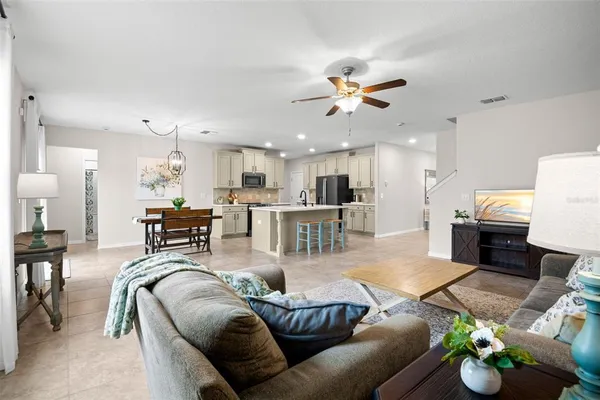 a living room with furniture kitchen view and a table