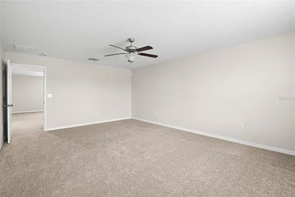 a view of an empty room with a fan