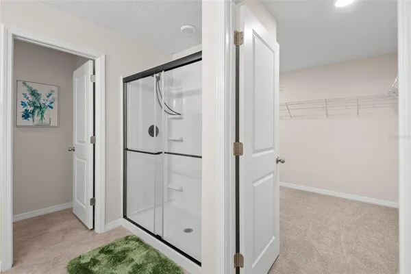 a bathroom with a shower and a glass door