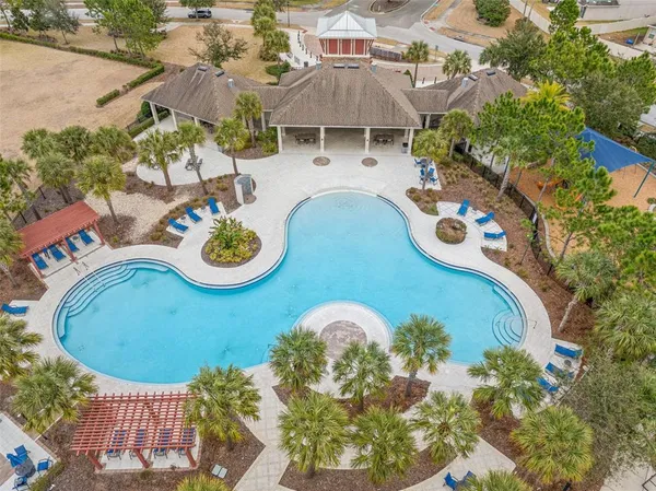 an aerial view of a house with garden space and swimming pool