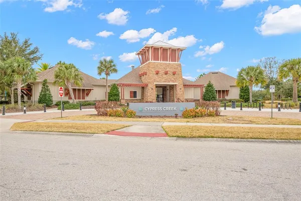 a view of white house with a swimming pool and a chairs