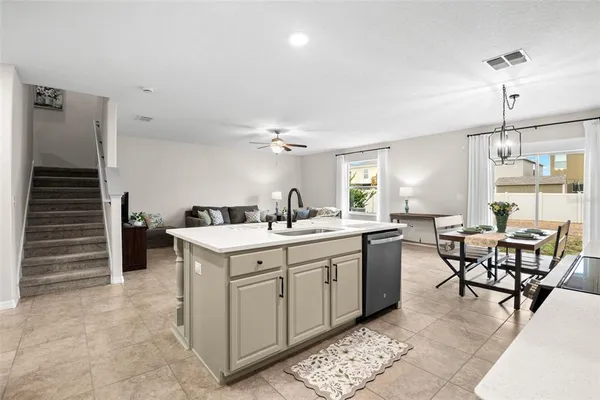 a kitchen that has a table and chairs in it
