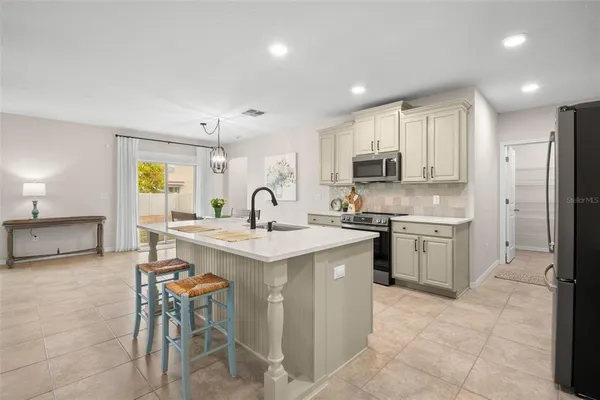 a kitchen with a sink stainless steel appliances and cabinets