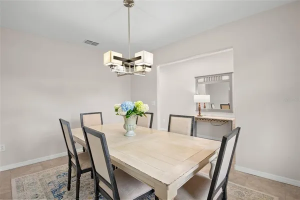 a view of a dining room with a table and chairs