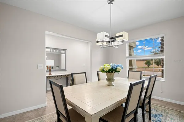 a view of a dining room with furniture and chandelier