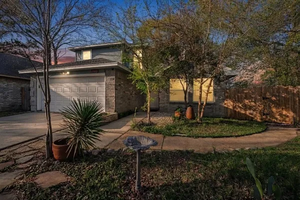 a yellow house with trees in front of it