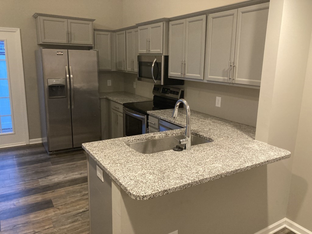 3526 Learning Lane Murfreesboro, TN 37128 - Photo 4 of 15 a kitchen with stainless steel appliances granite countertop a sink a refrigerator and wooden cabinets