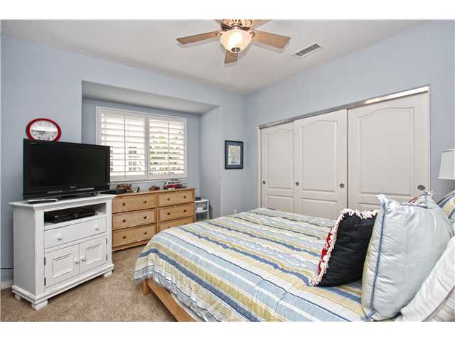 536 Rudder Avenue Carlsbad, CA 92011 - Photo 12 of 20 Upstairs bedroom with ceiling fan and plantation shutters.