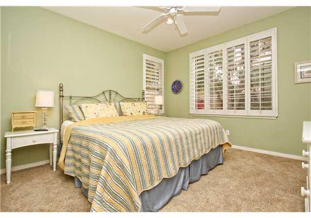 536 Rudder Avenue Carlsbad, CA 92011 - Photo 14 of 20 Downstairs guest bedroom with ceiling fan and plantation shutters.
