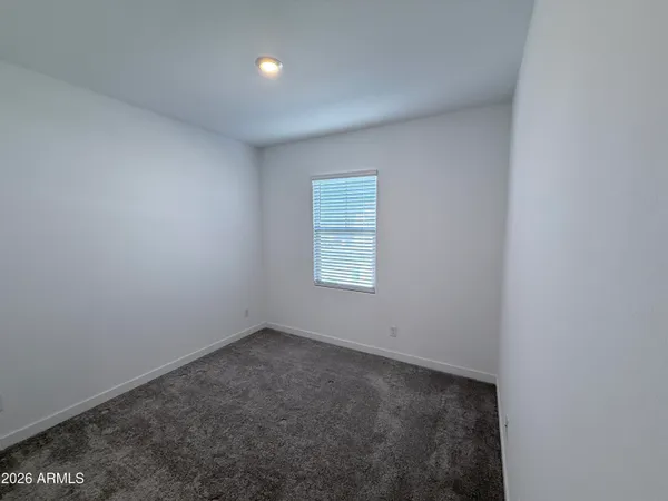 an empty room with a empty space and windows