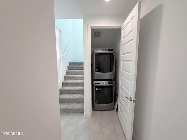 a view of a hallway with wooden floor and entryway