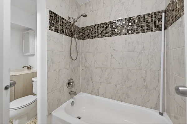 a bathroom with a bathtub and a toilet