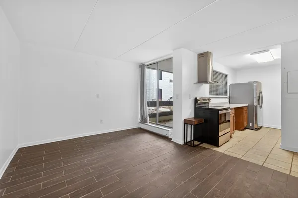 a kitchen with stainless steel appliances kitchen island granite countertop a sink and a refrigerator