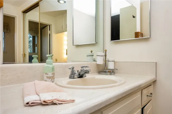 a bathroom with a double vanity sink and a mirror