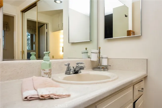 a bathroom with a double vanity sink and a mirror
