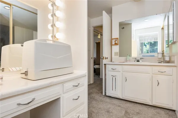 a bathroom with a glass shower door and a window