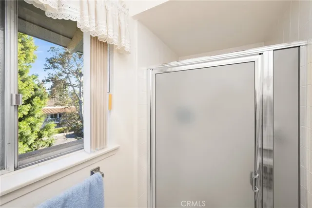 a bedroom with furniture and a large window