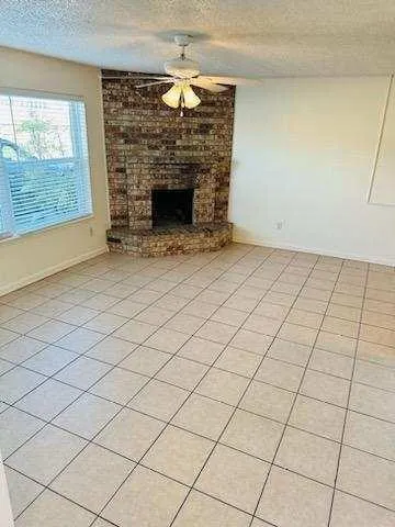 a view of empty room with fireplace
