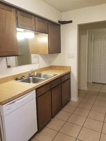 a kitchen with a sink cabinets and utility
