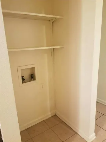 a bathroom with a granite countertop bathtub shower sink vanity and toilet