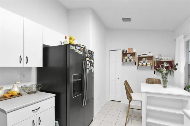 a kitchen with refrigerator and cabinets