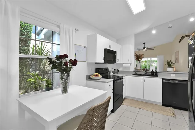 a kitchen with a stove a sink and a refrigerator