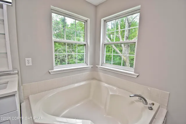 a bathroom with a double vanity sink a toilet and a mirror